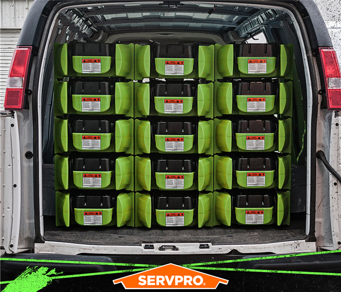 stacked air movers in a green van