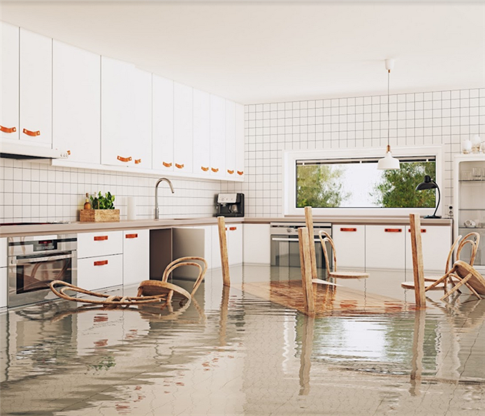 a flooded kitchen with furniture floating around
